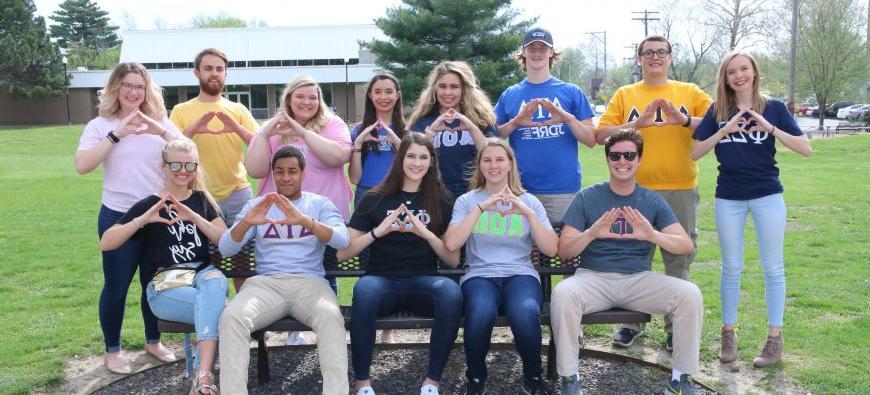 Greek life students making Greek symbols